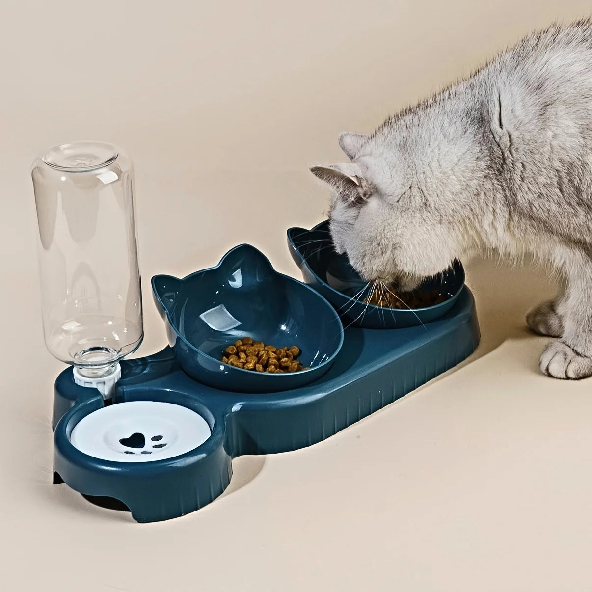 Comedero para gato con bebedero dosificador y dos comederos inclinados. Previene problemas en columna, cuello y ayuda a la digestión por su posición elevada.